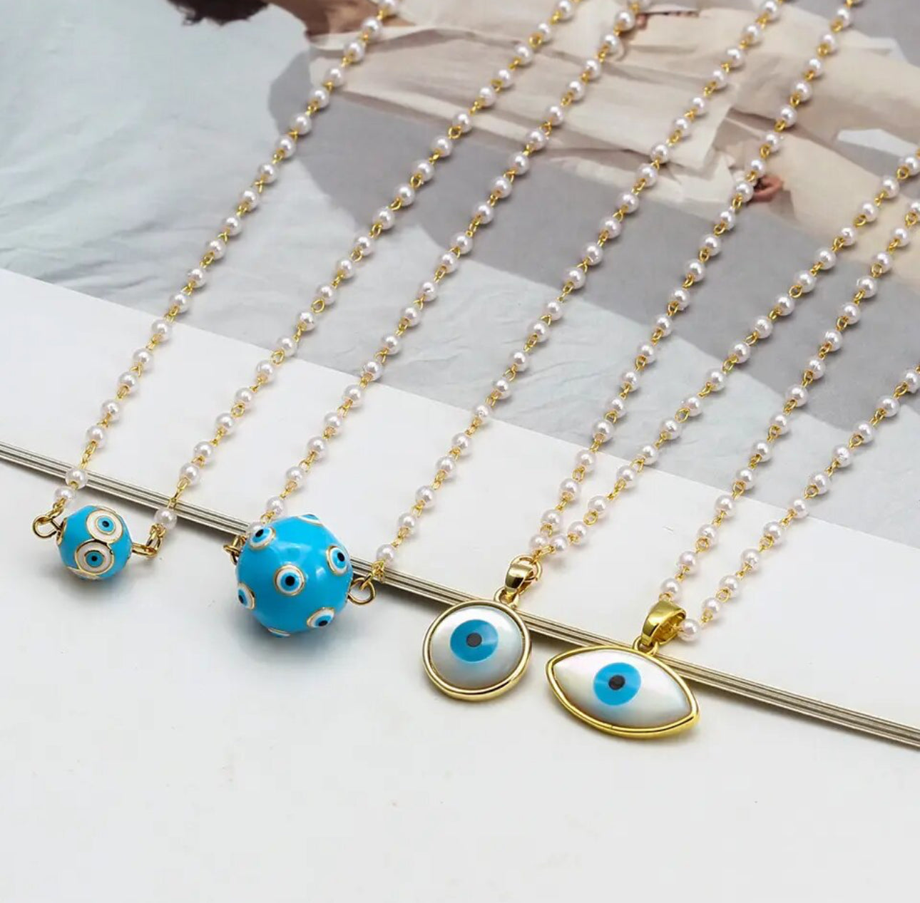 Round enameled evil eye pendant on dainty faux pearl chain | Erika Williner Designs